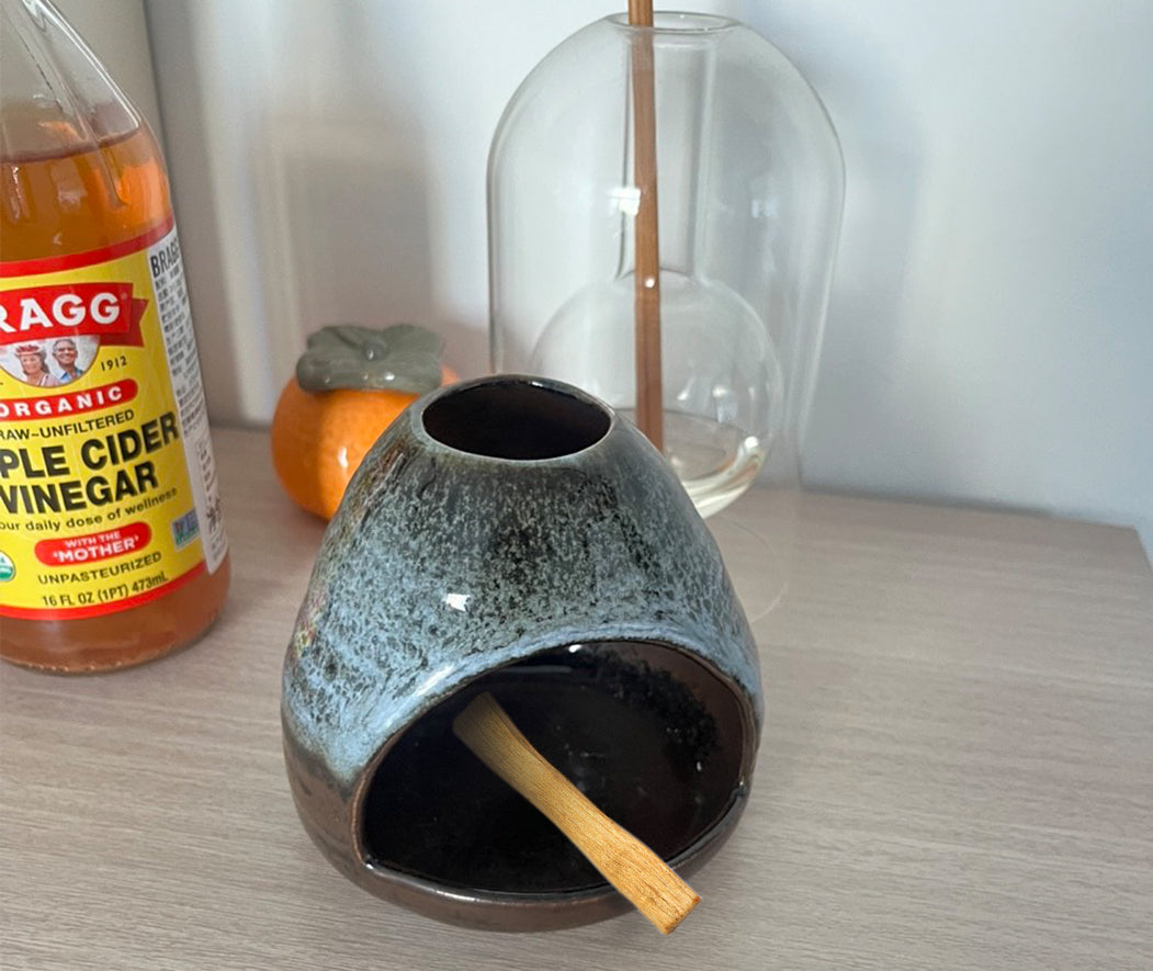 Customer review image featuring a ceramic Palo Santo holder designed for calming nightly wind‑down rituals